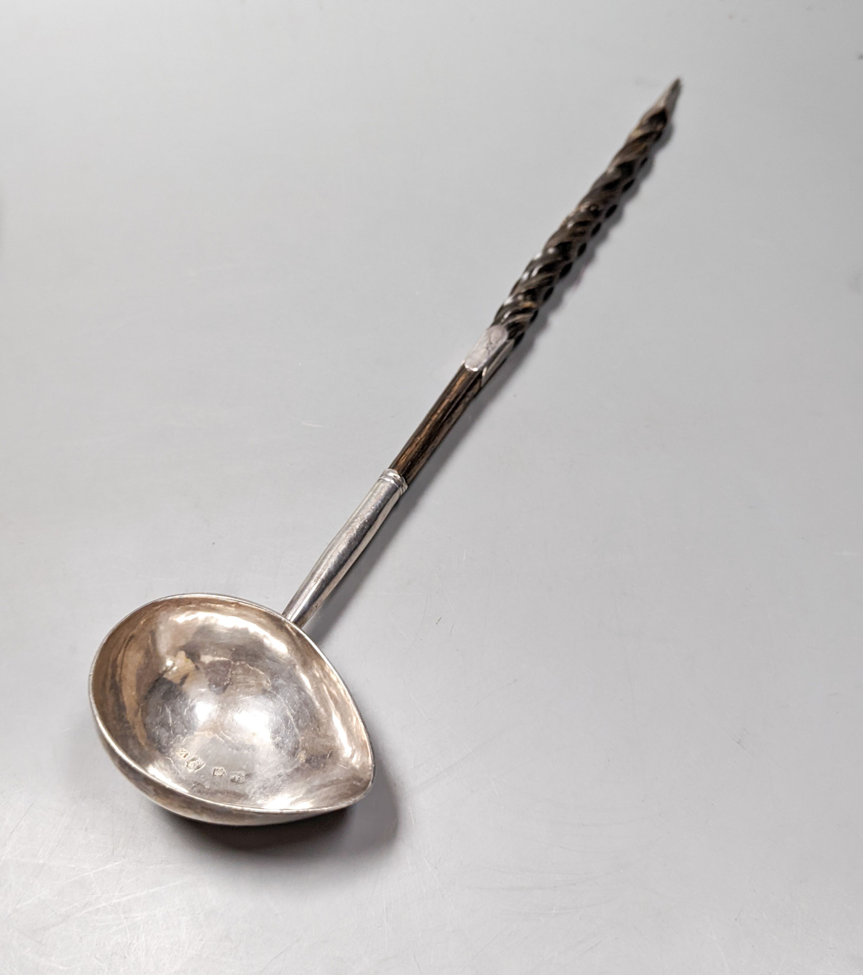 A George II silver toddy ladle, with spiral twist baleen handle, London, 1740 (a.f.) and a pair of later silver plated wine coasters, diameter 16.8cm.